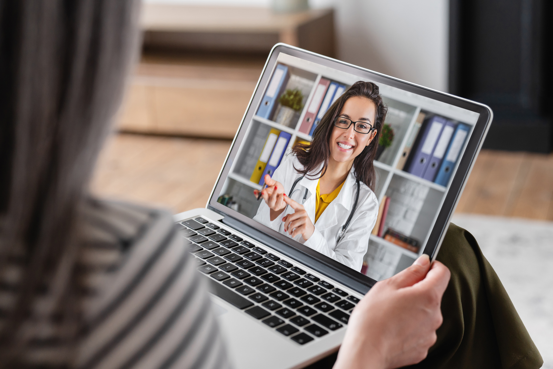 ALT Text: An older women talking to a medical professional on the computer as a virtual appointment.